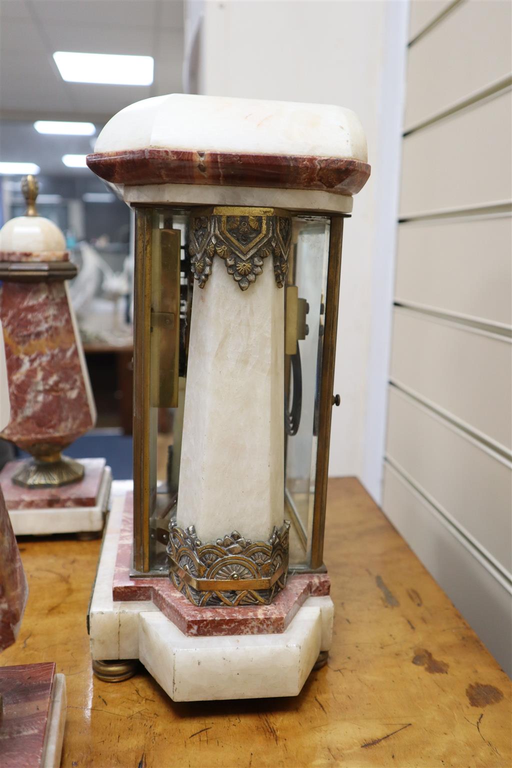 An Art Deco rouge and white marble clock garniture